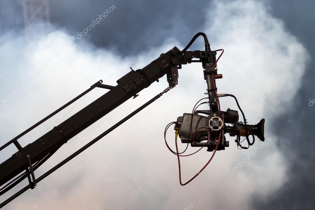 TV camera on a crane on football mach or concert