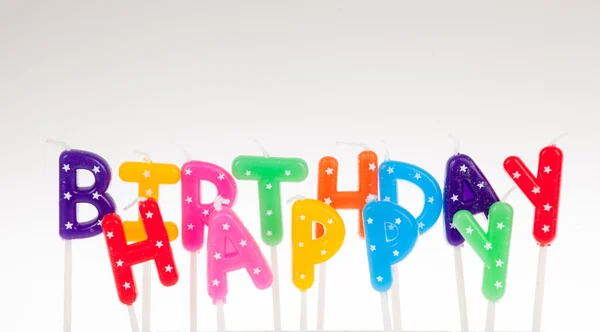 Colorful candles in letters saying Happy Birthday — Stock Photo, Image
