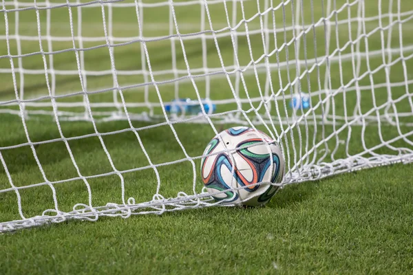 Varna, BULGARIA - 30 DE MAYO DE 2015: Primer plano de la Copa Mundial de Fútbol 2014 (Brazuca) en el gol (neto). Adidas, una importante empresa alemana — Foto de Stock