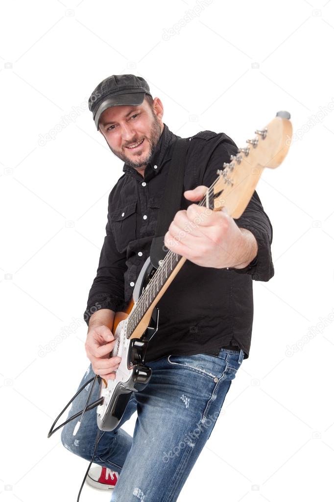 Young man with hat and beard play on electric guitar with enthusiasm. Isolated on white