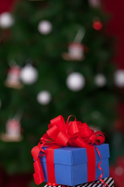 Blue gift box with red ribbon. Christmas theme — Stock Photo, Image