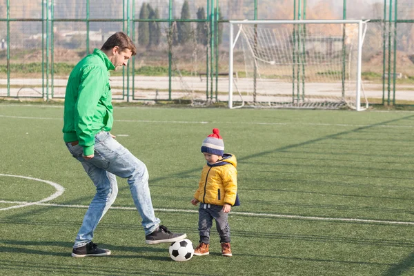 Young father with his little son playing football, soccer in the park — Stock Photo, Image