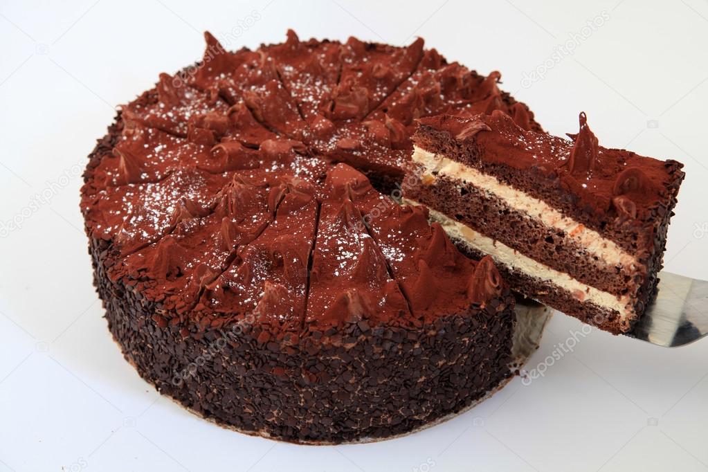 delicious chocolate cake with one piece cut from the whole cake