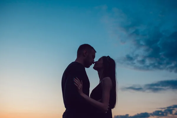 História de amor. Casal ao pôr-do-sol. No fundo do céu. Nuvens . — Fotografia de Stock