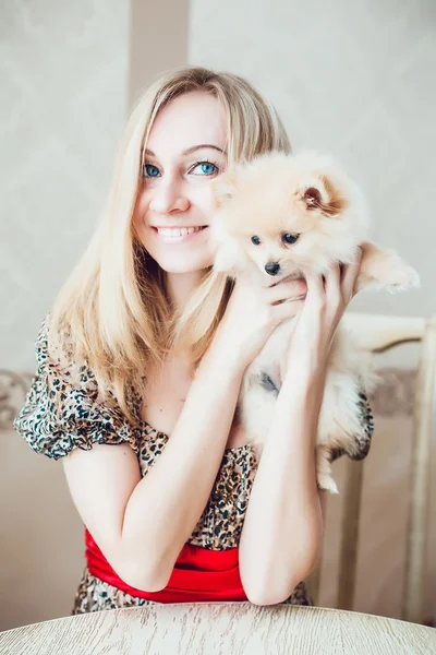 Hermosa mujer rubia con su perro en un hermoso interior —  Fotos de Stock