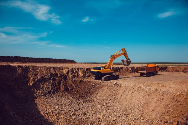 Ezilmiş taş ocağı bir kamyonetin içine Ekskavatör yükler stabilize