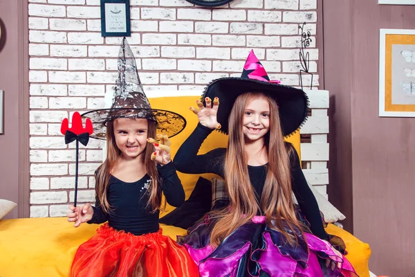 Girls, dressed up in Halloween costumes, show emotions of witches and vampires. — ストック写真