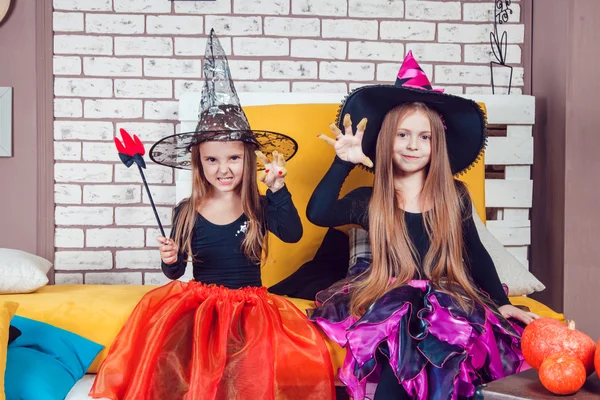 Girls, dressed up in Halloween costumes, show emotions of witches and vampires. — ストック写真