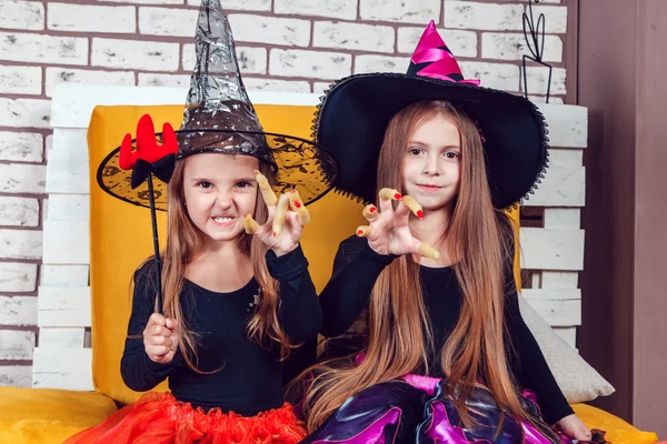 Girls, dressed up in Halloween costumes, show emotions of witches and vampires. — ストック写真