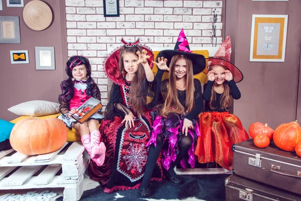 Girls, dressed up in Halloween costumes, show emotions of witches and vampires. — ストック写真