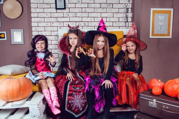 Girls, dressed up in Halloween costumes, show emotions of witches and vampires. — ストック写真