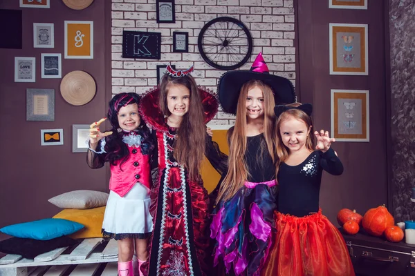 Girls, dressed up in Halloween costumes, show emotions of witches and vampires. — ストック写真