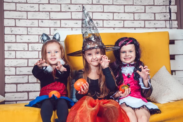 Girls, dressed up in Halloween costumes, show emotions of witches and vampires. — Stok fotoğraf