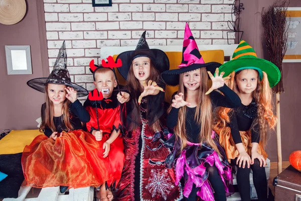 Boys and girls, dressed up in Halloween costumes, show emotions of witches and vampires. Halloween party with group children. — Stok fotoğraf