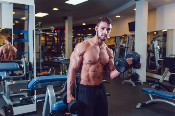 Very power athletic guy bodybuilder , execute exercise with dumbbells — Stock Photo, Image