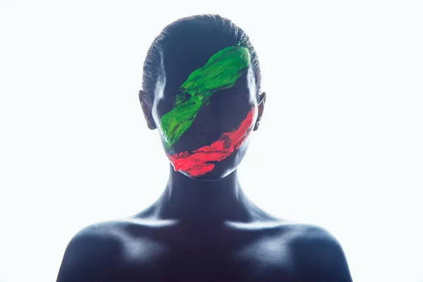 Girl with a black paint on the face. Green and red stripes. — Stock Photo, Image