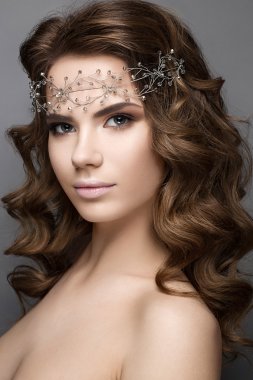 Beautiful girl in an image of bride with a diadem on her head. Beauty face