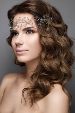 Beautiful girl in an image of bride with a diadem on her head. Beauty face