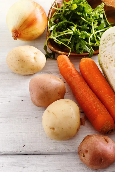 Organic winter vegetables on white wooden table — Stock Photo, Image