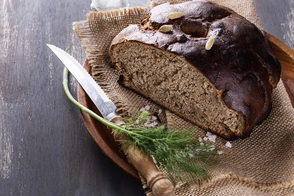 Homemade rye bread over wooden background — Stock Photo, Image