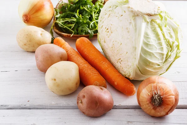 Organic winter vegetables on white wooden table — Stock Photo, Image