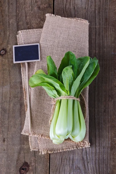 Bock Choy over rustic wooden background — Stock Photo, Image