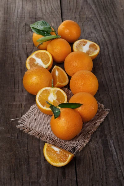 Organic oranges on a rustic wooden background — Stock Photo, Image