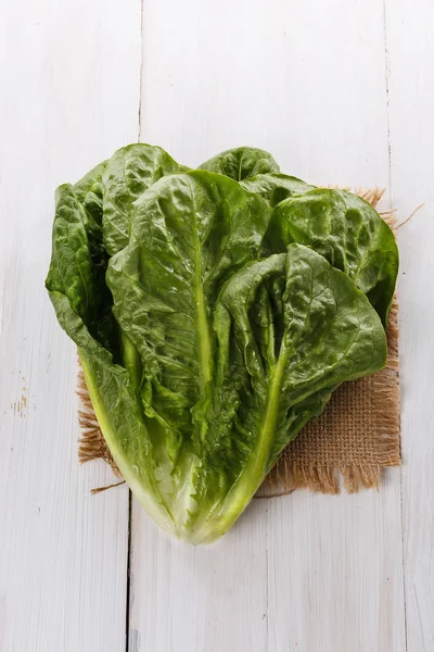 Cos lettuce over white wooden background — Stock Photo, Image