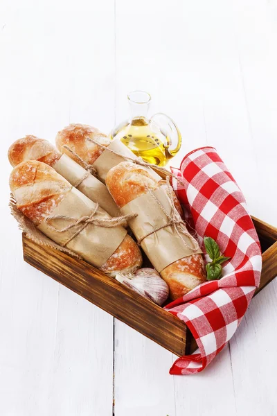 Freshly baked bread rolls over white wooden background — Stock Photo, Image