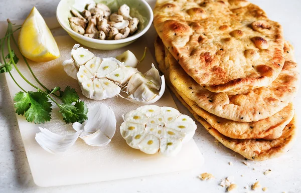 Pile of flat bread and spices on a table — Stock Photo, Image
