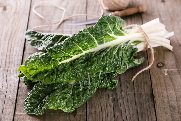 Bunch of silverbeet on a rustic wooden background — Stock Photo, Image