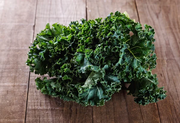 Organic kale on a rustic wooden background — Stock Photo, Image