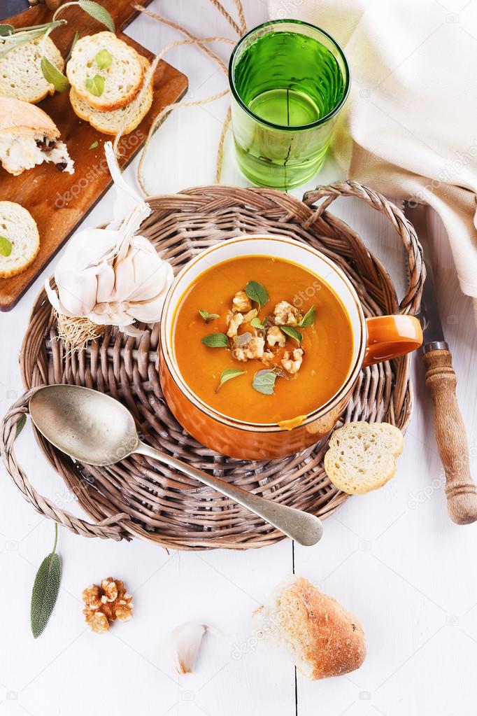 Pumpkin soup with bread on white background