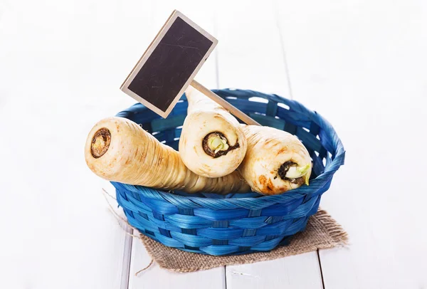 Pparsnips in a blue woven basket — Stock Photo, Image