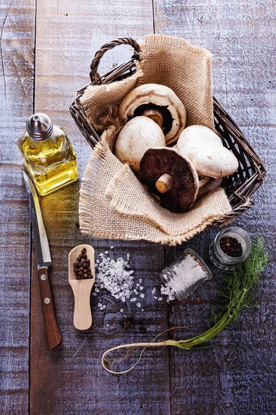 Top view of mushrooms and spices over rustic wooden background — Stock Photo, Image