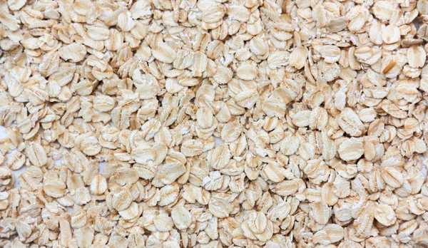 Pile of dry oat flakes, evenly layer background