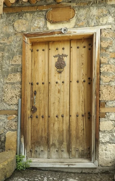 Ancient door in the village of Kemal. Symbolic handles on the doors.