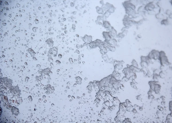 Śnieg spadek tekstury na szybę. — Zdjęcie stockowe