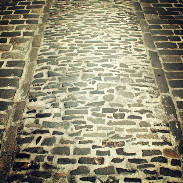 Old paving useful as a background - retro filter. — Stock Photo, Image