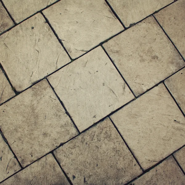 Typical pavement. Stone roadway. Diagonal pattern. — Stock Photo, Image