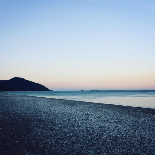 Cirali 湾夕暮れ時。穏やかな水。後半のピンクの夕日. — ストック写真