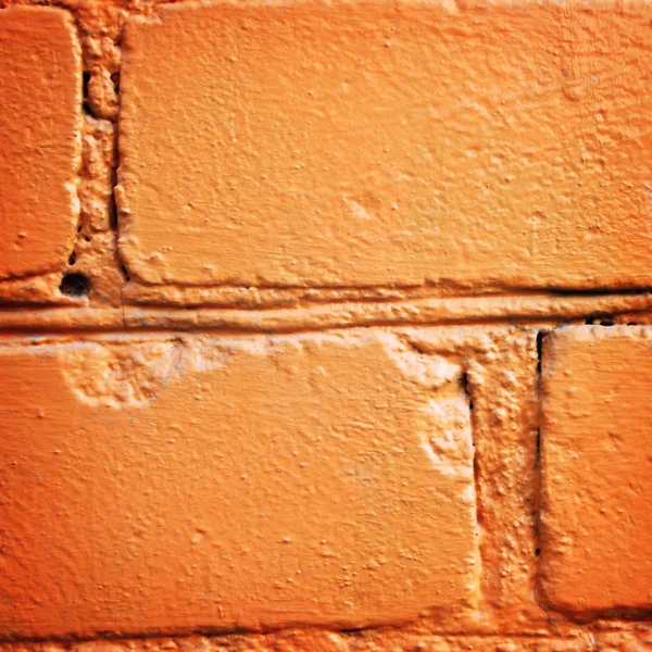 Τοίχο από τούβλα ζωγραφισμένα πορτοκαλί. Γκρο πλαν φωτογραφία. — Φωτογραφία Αρχείου