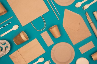 Çevre dostu sofra takımı ile yatıyordu. Yeşil arka planda Kraft kağıt gıda ambalajı. Sokak yiyecekleri ambalajı, geri dönüşümlü kağıtlar ve sıfır atık ambalaj konsepti. Modelleme. Seçici odak