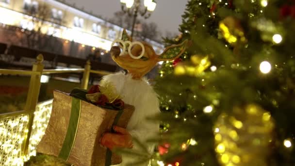 Silvesterspielzeug am Baum. Fuchs mit Geschenken zu Weihnachten. Festliche Dekoration der Stadt. — Stockvideo