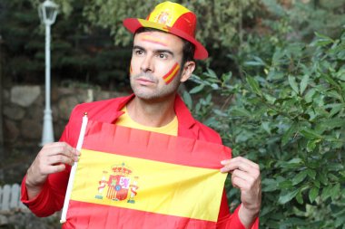 İspanya bayrağını doğada boyayan yakışıklı genç adamın portresi.