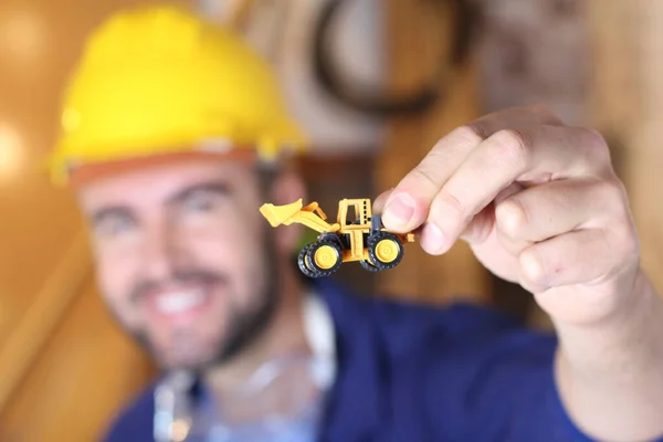 Portrait Handsome Young Repairman Holding Toy Excavator His Workshop — Fotografia de Stock