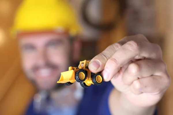 Portrait Handsome Young Repairman Holding Toy Excavator His Workshop — Fotografia de Stock