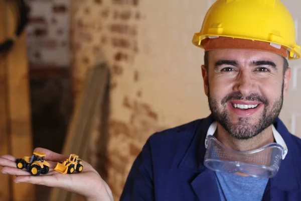 Portrait Handsome Young Repairman Holding Toy Excavators His Workshop — Fotografia de Stock