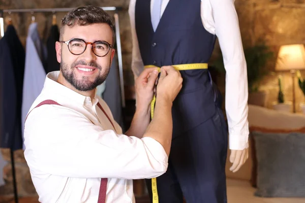 portrait of handsome youth fashion designer in his workshop