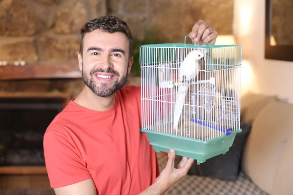 Close Portrait Handsome Young Man Holding Cage Parrot Home — Stockfoto